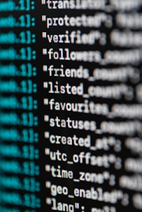 A close-up view of computer code or data displayed on a screen. The text appears to be part of a JSON-like structure with key-value pairs, featuring words such as 'protected', 'verified', and 'followers'. The text is in white, while some metadata or index numbers are in green.