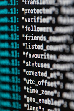 A close-up view of computer code or data displayed on a screen. The text appears to be part of a JSON-like structure with key-value pairs, featuring words such as 'protected', 'verified', and 'followers'. The text is in white, while some metadata or index numbers are in green.