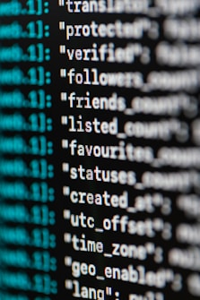 A close-up view of computer code or data displayed on a screen. The text appears to be part of a JSON-like structure with key-value pairs, featuring words such as 'protected', 'verified', and 'followers'. The text is in white, while some metadata or index numbers are in green.