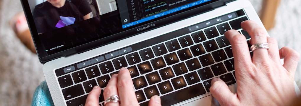 person using macbook pro on table