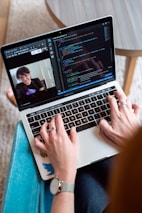 person using macbook pro on table