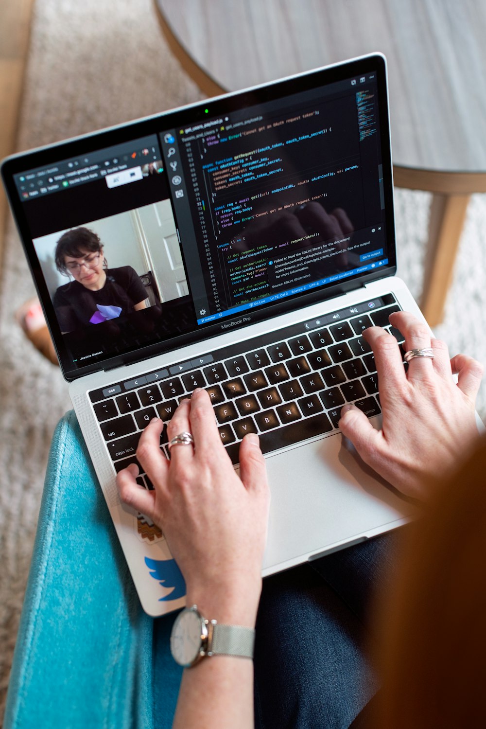 person using macbook pro on table