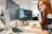 woman in green shirt sitting in front of computer