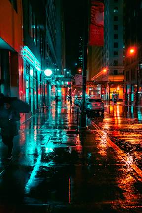 a person walking down a street holding an umbrella