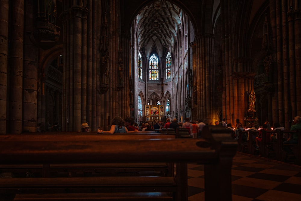 people sitting on bench inside cathedral