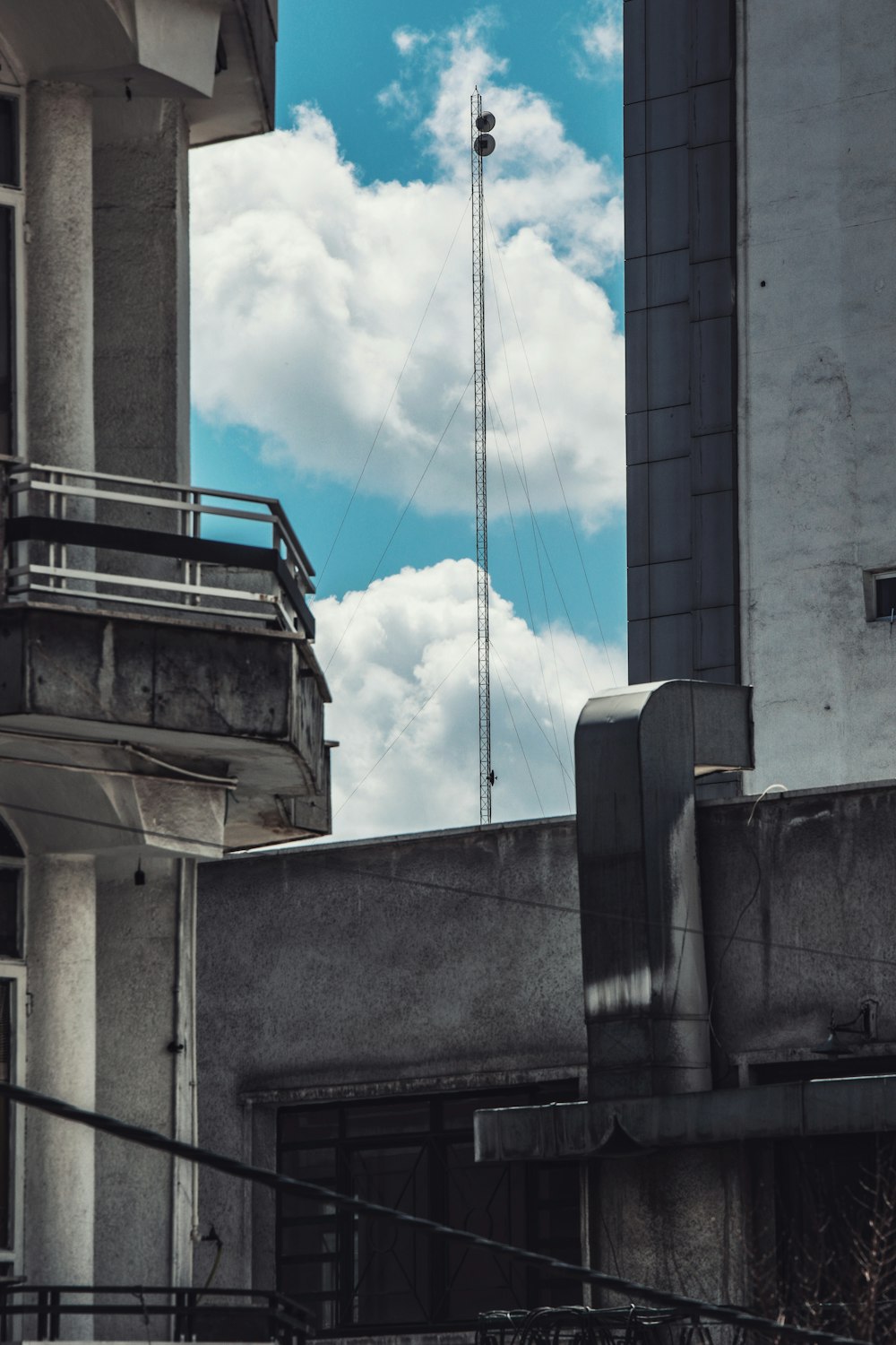 a tall building with a radio tower in the background