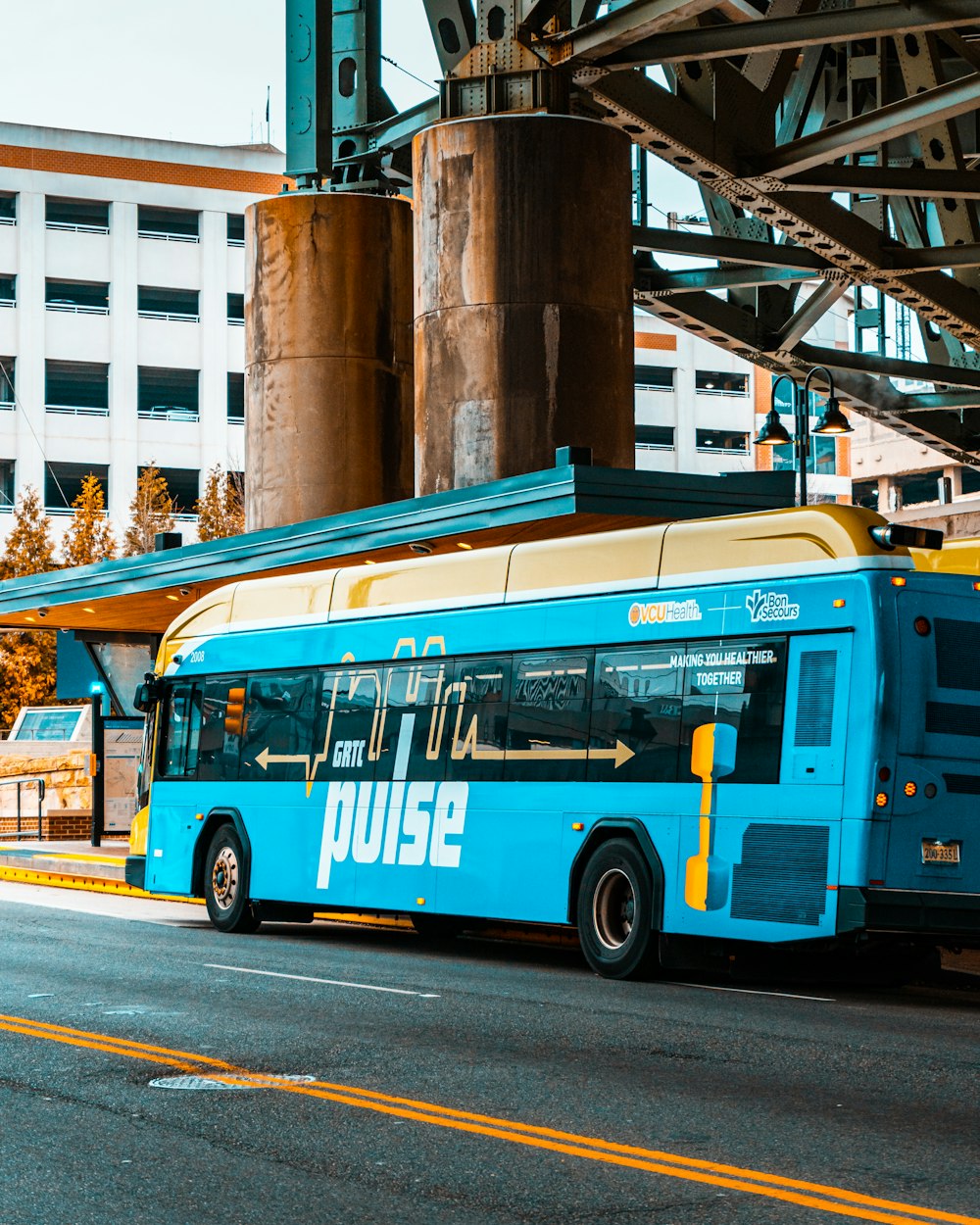 blue and brown bus on road during daytime