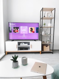 black flat screen tv turned on displaying man in black suit