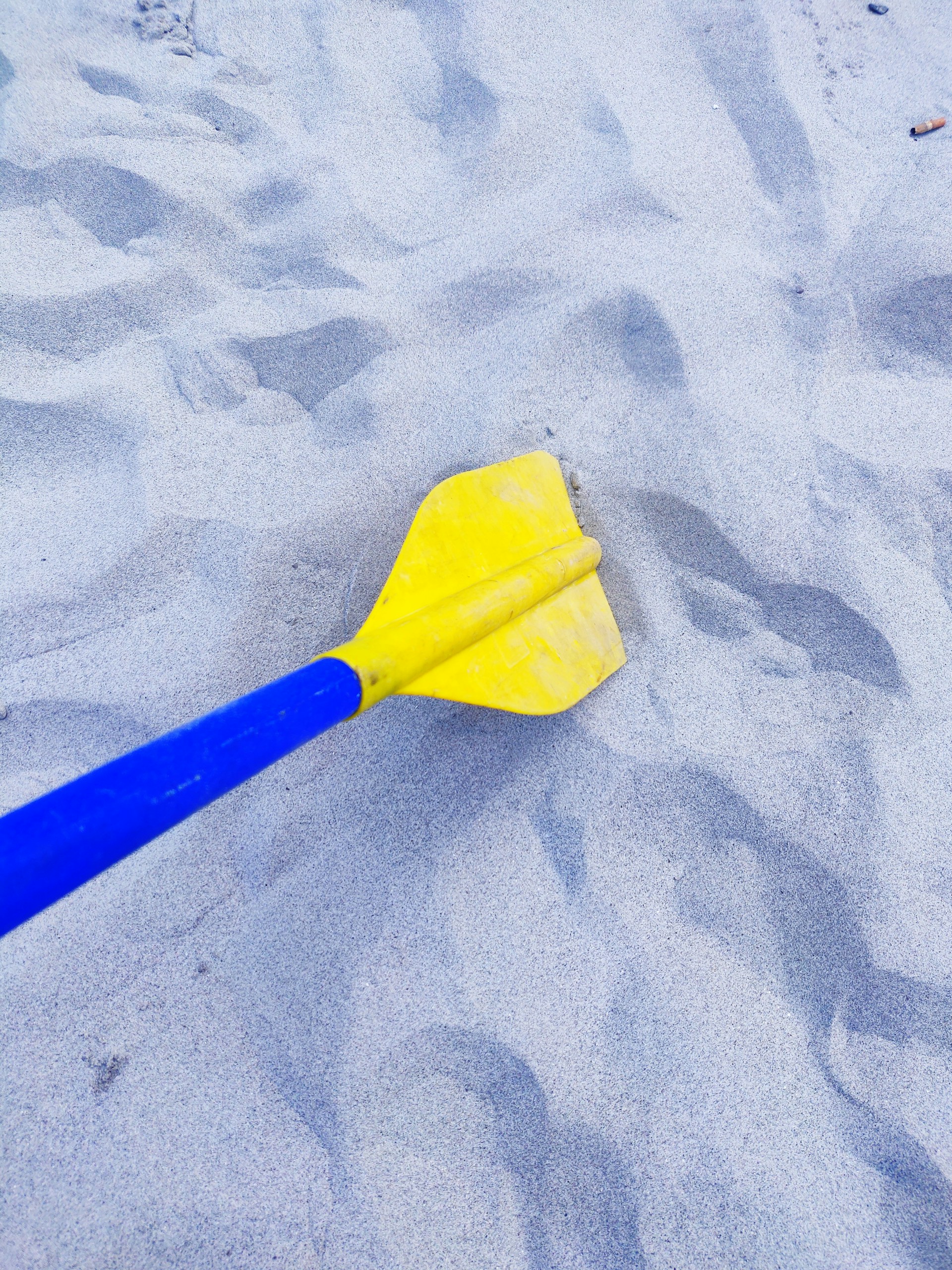 yellow plastic stick on blue textile