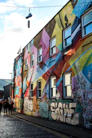 Urban shoes showcased against a backdrop of colorful city murals at sunset.