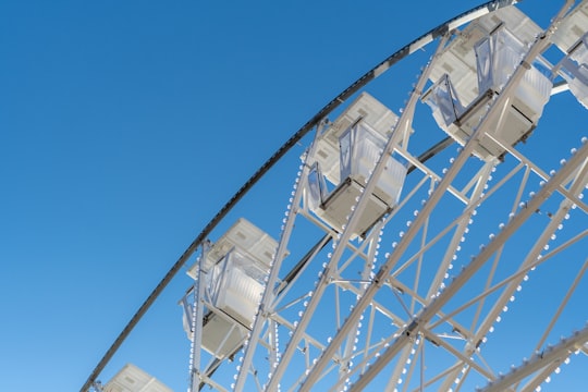 white ferris wheel under blue sky during daytime in Sibiu Romania