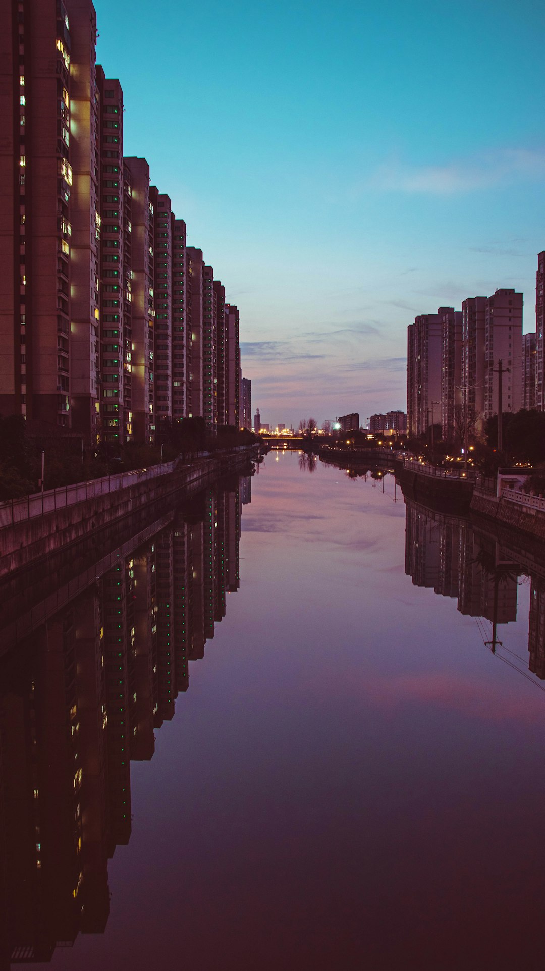 body of water between high rise buildings during daytime