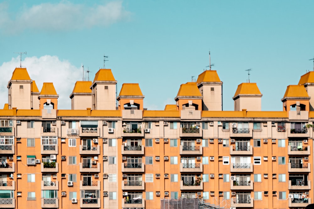 brown and beige concrete building under blue sky during daytime