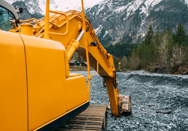 yellow and black heavy equipment on rocky ground