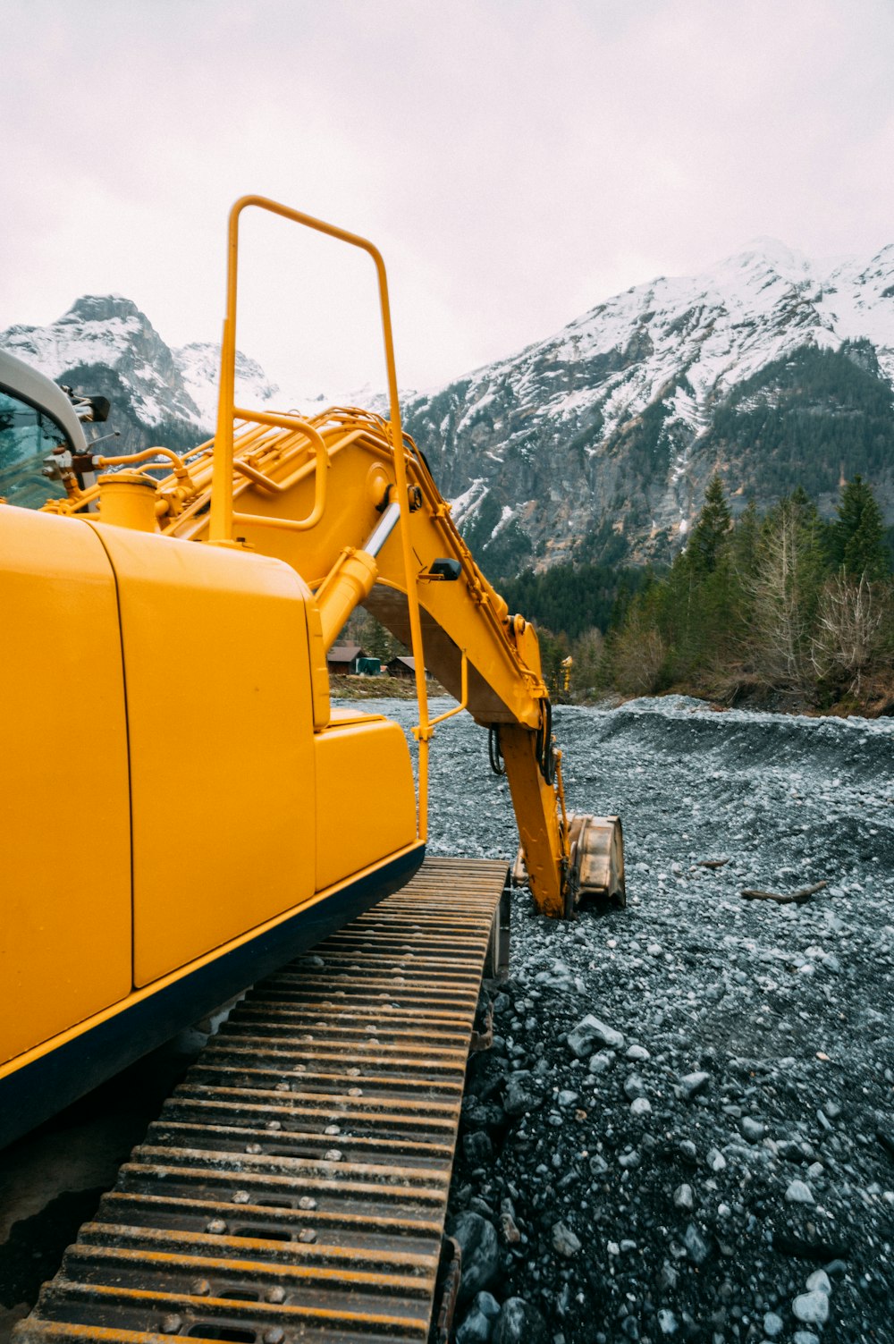 yellow and black heavy equipment on rocky ground