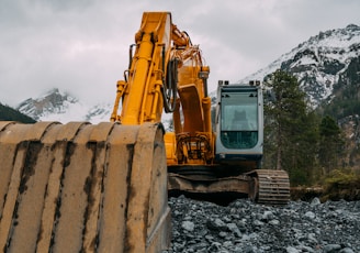 yellow and black heavy equipment on rocky ground