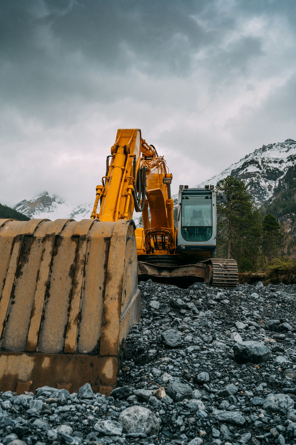 yellow and black heavy equipment on rocky ground