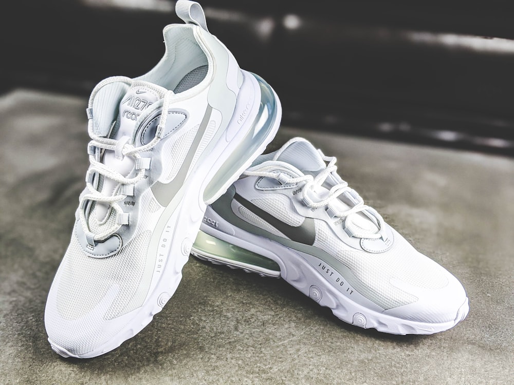 white and gray nike athletic shoes