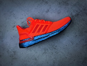 red and blue nike athletic shoe