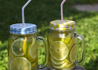 three clear glass mason jars with straws