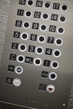 A sleek, modern elevator control panel with metallic accents reflecting premium engineering.