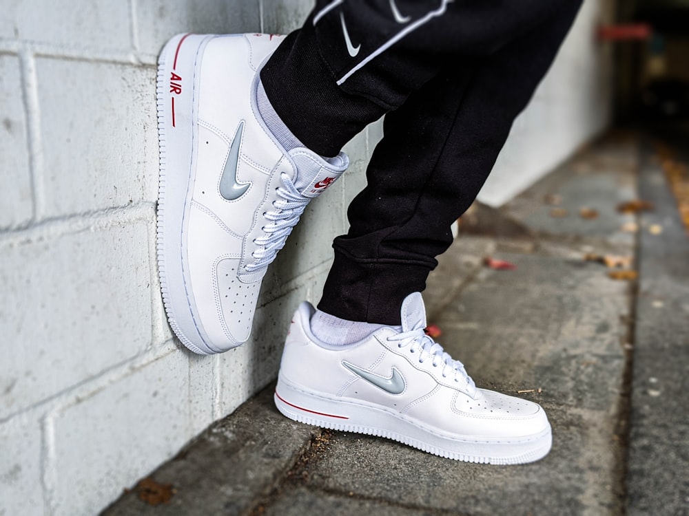 person in white nike air force 1 high