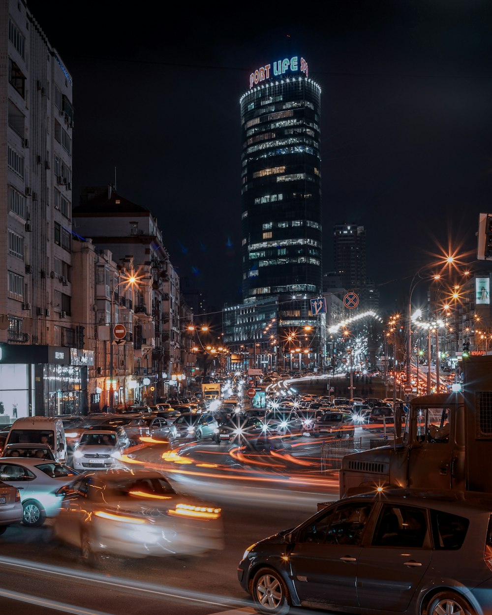 cars parked on side of the road during night time