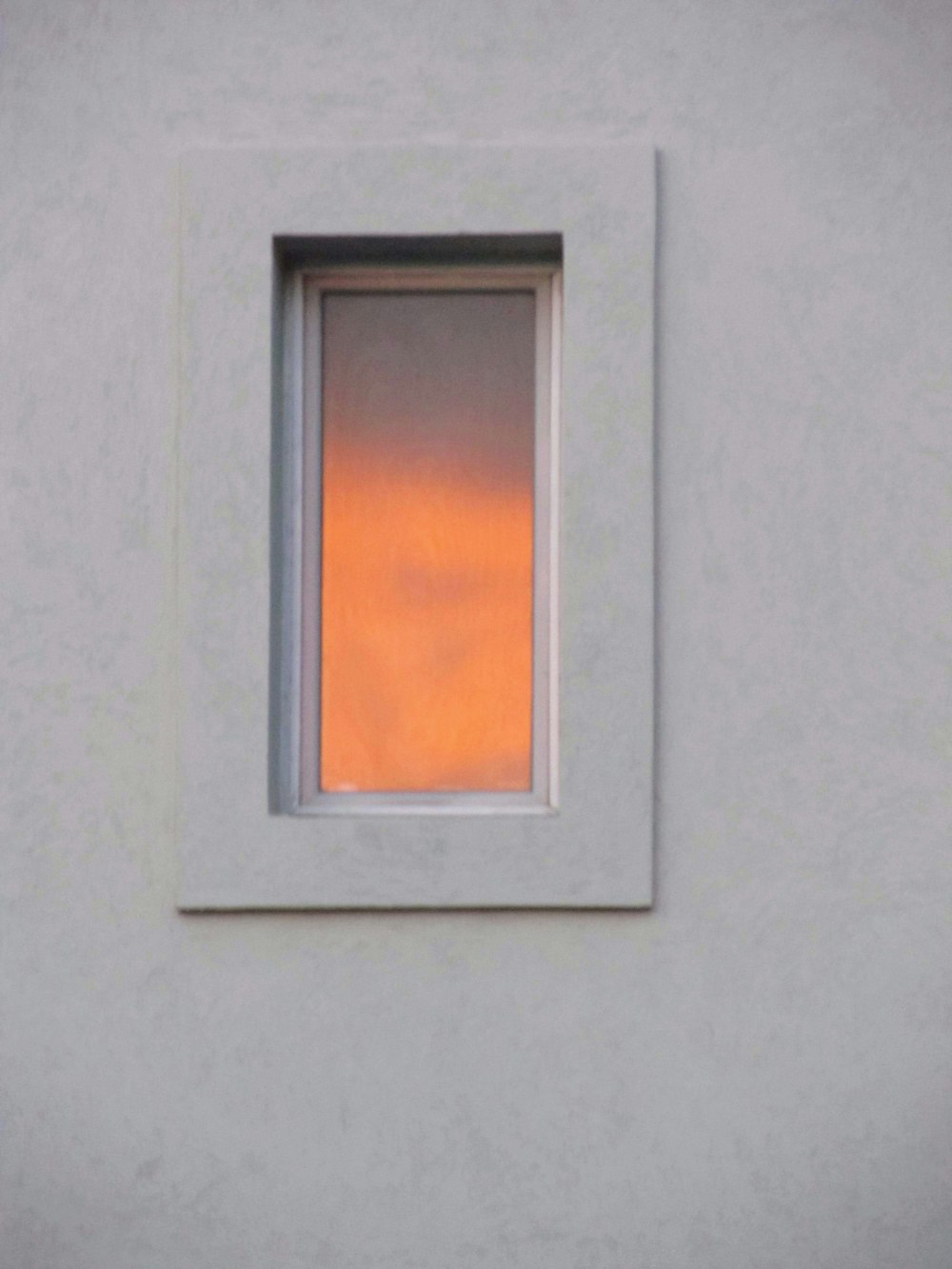 grey framed orange sun painting
