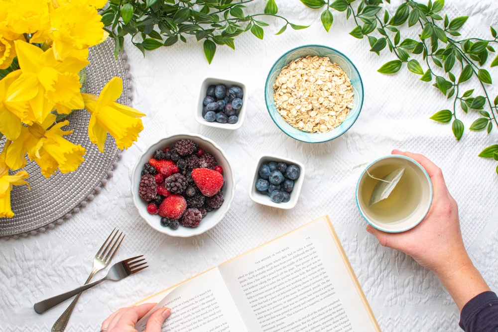 white ceramic mug beside white ceramic bowl with food