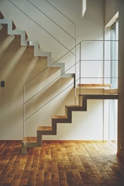 brown wooden staircase with white wooden railings