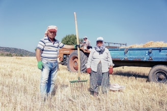 man in white and black stripe polo shirt standing beside man in gray and white stripe