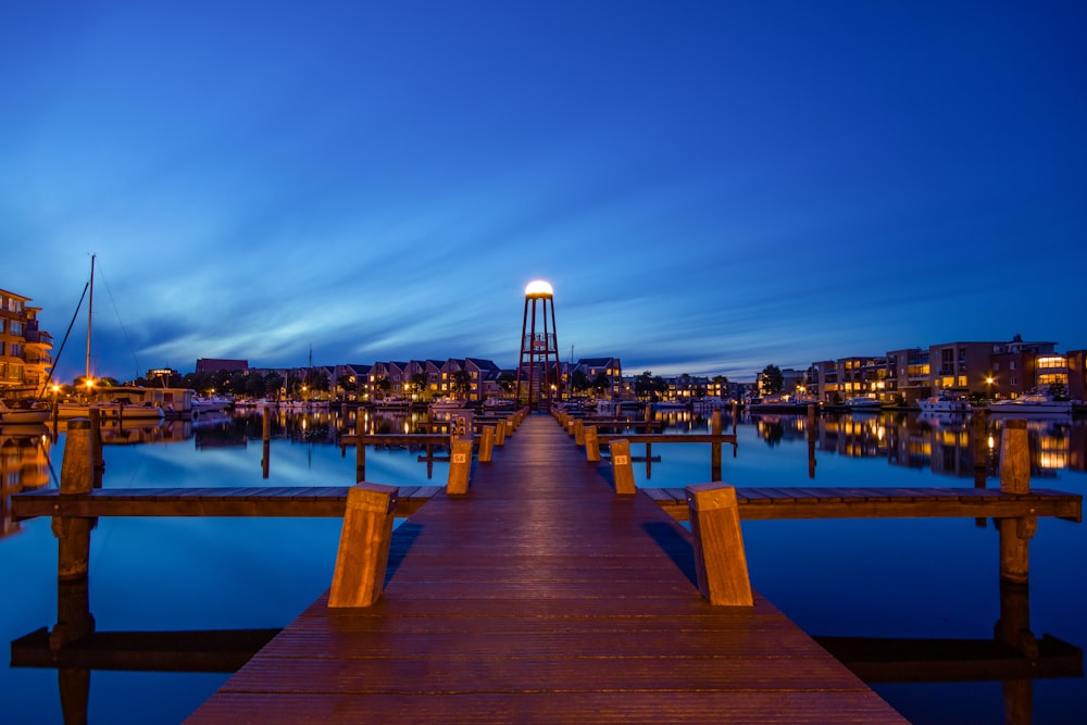 brown wooden dock on body of water during night time