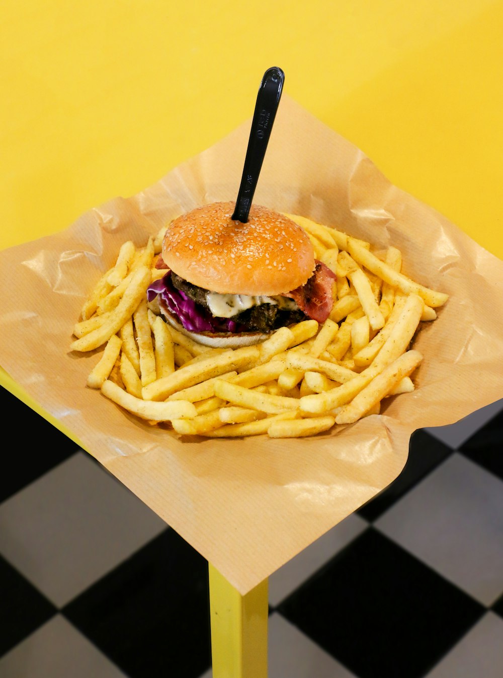 burger with fries on white paper