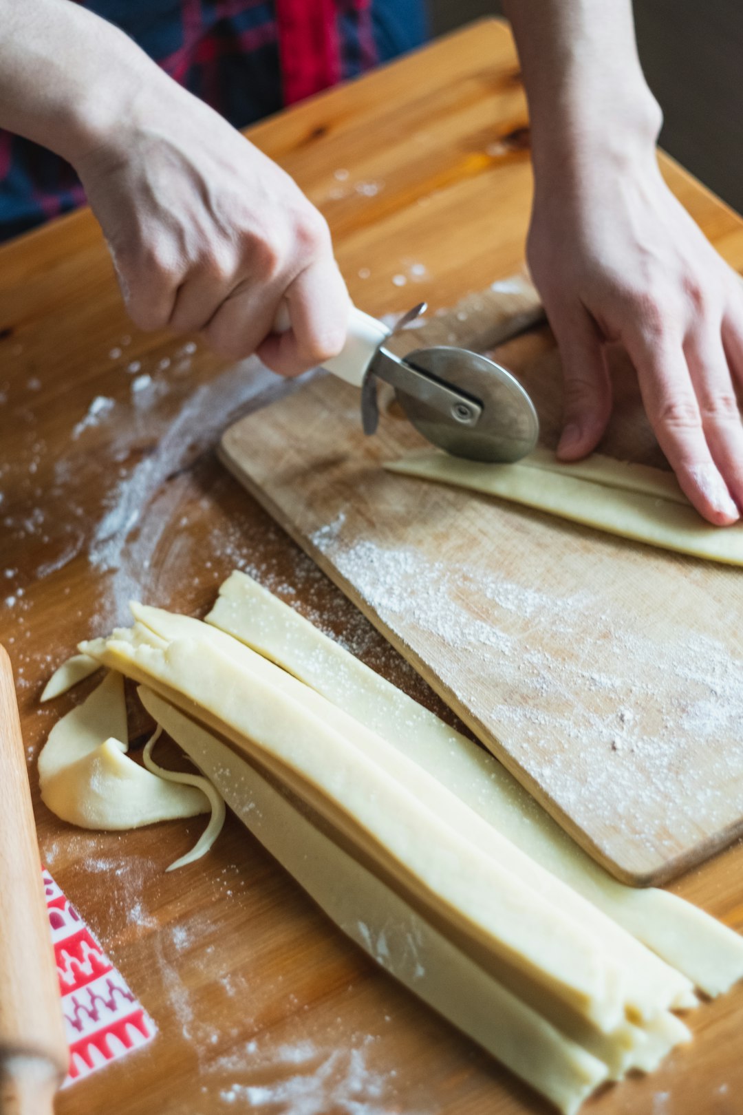 person slicing brown wooden chopping board