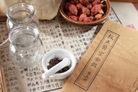 white ceramic mug on white ceramic saucer beside clear glass jar