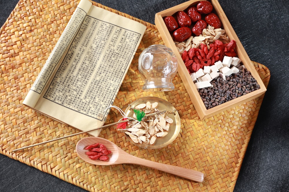 red round fruits on clear glass bowl beside white printer paper