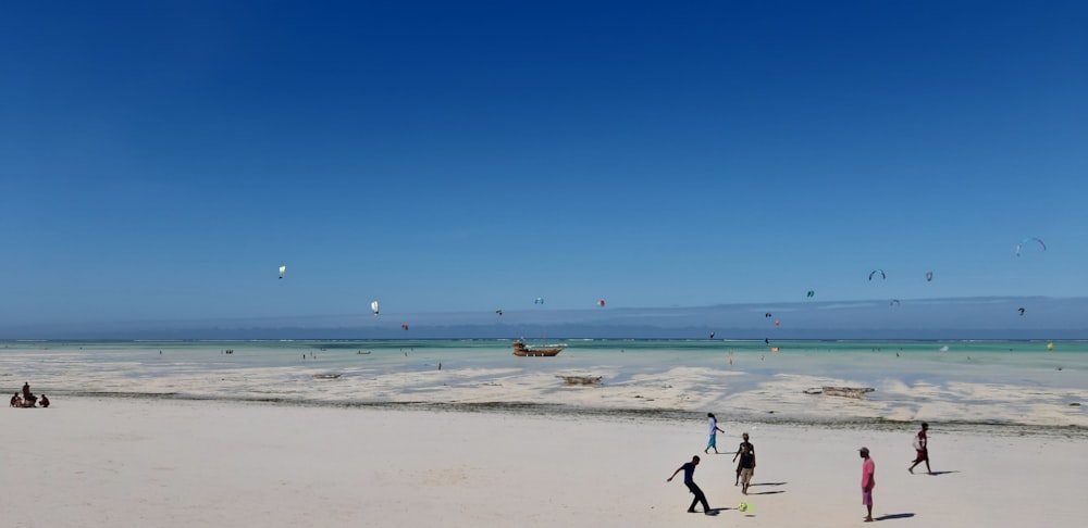 man in black shirt and black shorts jumping on beach during daytime