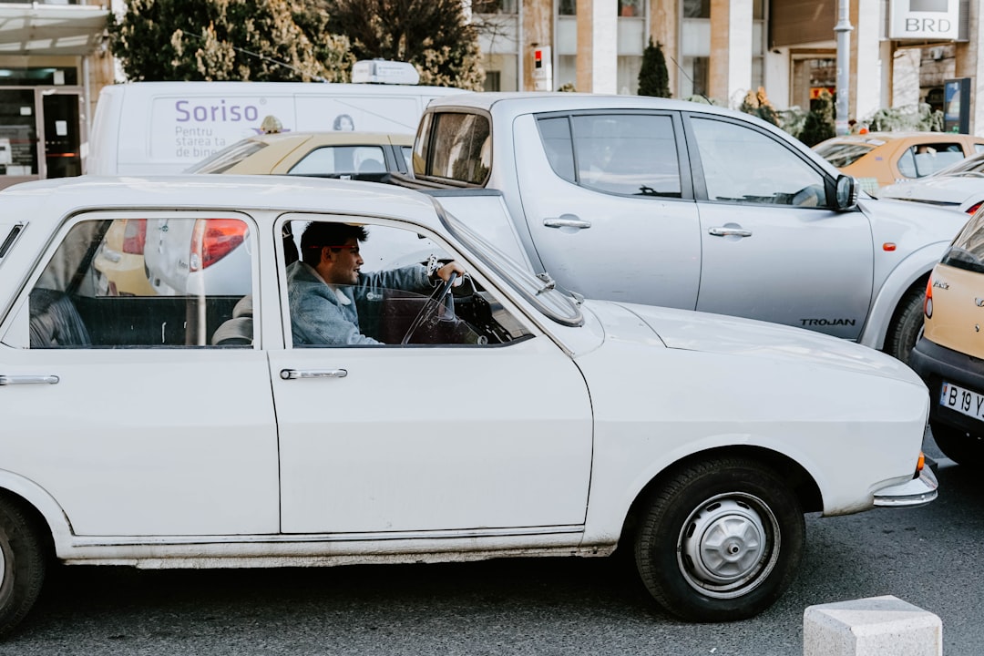 white car parked on street during daytime