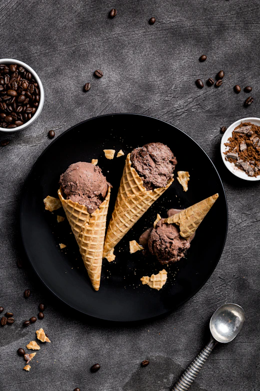 Dark chocolate vegan ice cream cones on a slate plate