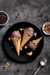 waffle with chocolate ice cream on black round plate