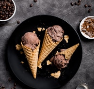 waffle with chocolate ice cream on black round plate