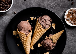 waffle with chocolate ice cream on black round plate