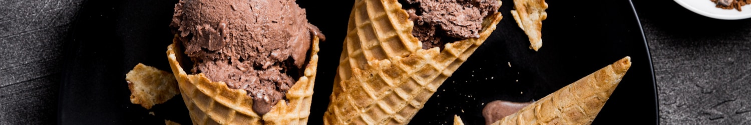 waffle with chocolate ice cream on black round plate