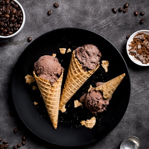 waffle with chocolate ice cream on black round plate