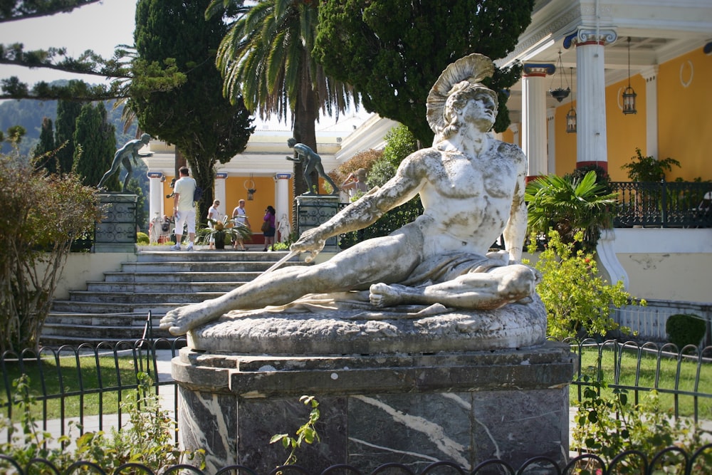 white concrete statue of man