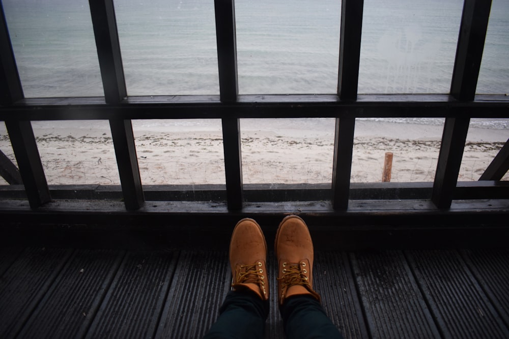 person wearing brown leather shoes