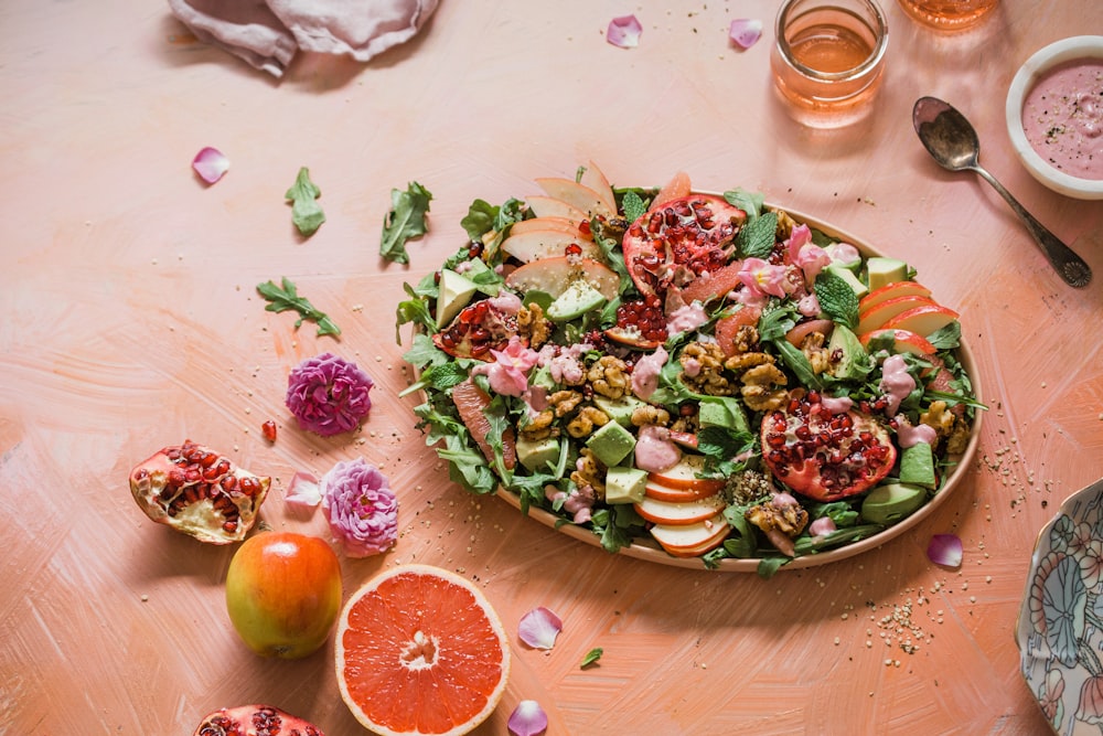 pizza with green and red vegetable on brown wooden table