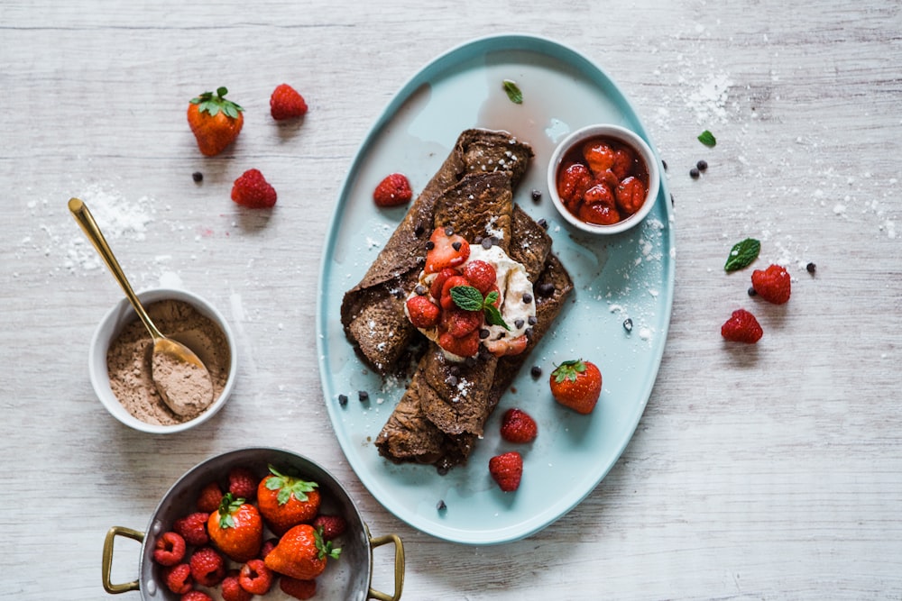 sliced bread with sliced strawberries and sliced of bread on blue ceramic plate