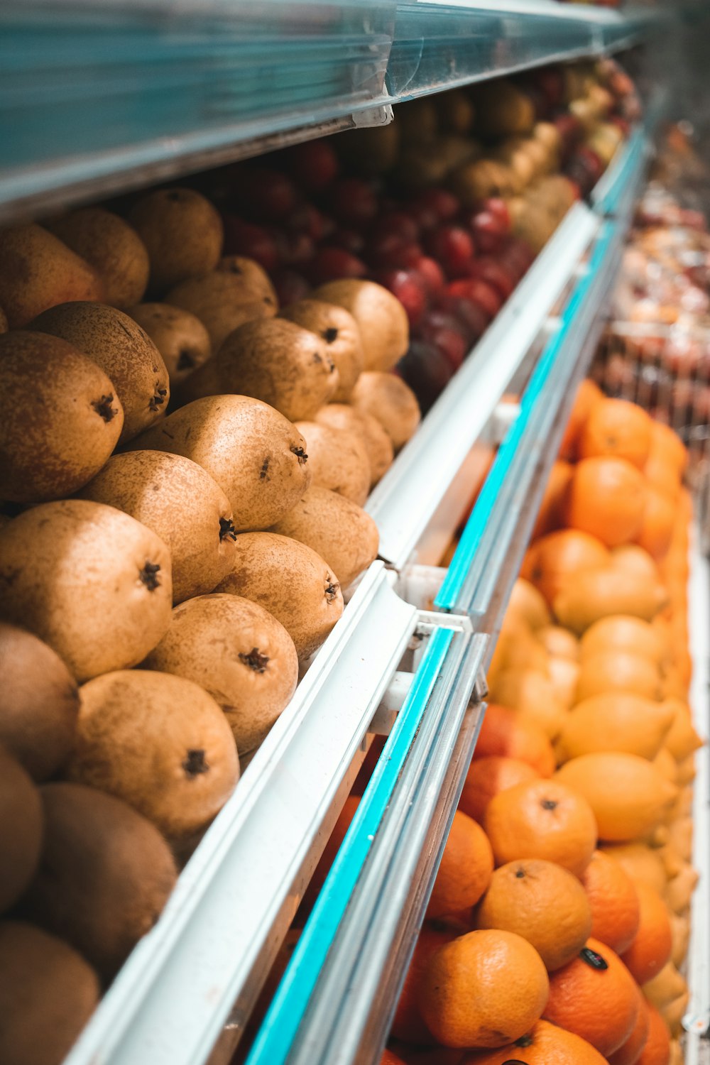 brown round fruits on white plastic crate