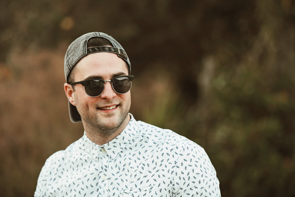 man in white and black crew neck shirt wearing black sunglasses